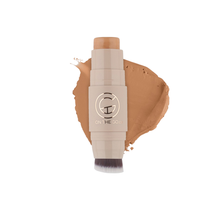 Makeup stick with a swatch of brown color on a white background